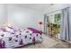 Cozy bedroom with a floral comforter, area rug, and natural light from the window at 9593 Indian Beech Nw Ave, Concord, NC 28027