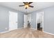 Bedroom with neutral carpet and walls, ceiling fan, and doors to hall and bathroom at 9593 Indian Beech Nw Ave, Concord, NC 28027