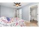 Bedroom with neutral carpet and walls, ceiling fan, and entry to bathroom at 9593 Indian Beech Nw Ave, Concord, NC 28027
