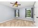 Bedroom with neutral carpet and walls, ceiling fan, and natural light from two windows at 9593 Indian Beech Nw Ave, Concord, NC 28027
