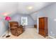 Bonus room featuring carpet, neutral colors, a chair, and natural light from a window at 9593 Indian Beech Nw Ave, Concord, NC 28027