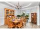 Formal dining room with wood table set for six, chandelier, and natural light at 9593 Indian Beech Nw Ave, Concord, NC 28027