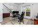 Bright home office featuring a large window, wood floors, and modern office furniture at 9593 Indian Beech Nw Ave, Concord, NC 28027