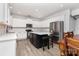 Well-lit kitchen featuring white cabinets, a center island with seating, and stainless steel appliances at 9593 Indian Beech Nw Ave, Concord, NC 28027
