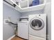 Bright laundry room featuring white front-load washer and dryer at 9593 Indian Beech Nw Ave, Concord, NC 28027