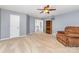 Large living room with comfortable chair, bookshelf, ceiling fan, and neutral colored carpet at 9593 Indian Beech Nw Ave, Concord, NC 28027