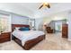 Spacious main bedroom with neutral carpet, ceiling fan, accent chair, and lots of natural light at 9593 Indian Beech Nw Ave, Concord, NC 28027