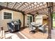 Inviting outdoor patio with shade structure, ceiling fan, and outdoor dining area at 9593 Indian Beech Nw Ave, Concord, NC 28027