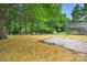 Large backyard with mature trees, a gravel area, and a wooden pergola over concrete pavers at 9826 Meringue Pl # 15, Charlotte, NC 28270