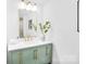 Chic bathroom featuring a green vanity, gold fixtures, and modern decorative mirror at 9826 Meringue Pl # 15, Charlotte, NC 28270