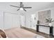 Bright bedroom with wood-look floors, ceiling fan, walk-in closets, and ensuite bath access at 9826 Meringue Pl # 15, Charlotte, NC 28270