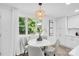 Inviting dining area with a modern light fixture, a view of the yard, and seating for four at 9826 Meringue Pl # 15, Charlotte, NC 28270