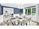 Bright dining room features modern chandelier, wainscoting and large windows at 9826 Meringue Pl # 15, Charlotte, NC 28270