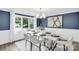 Elegant dining room with modern decor, statement lighting, and a view of the outdoors at 9826 Meringue Pl # 15, Charlotte, NC 28270