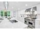 Bright kitchen with quartz countertops, white cabinets, stainless steel appliances, and stylish pendant lighting at 9826 Meringue Pl # 15, Charlotte, NC 28270