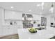 Bright kitchen with white cabinets, stainless steel appliances, quartz countertops, and modern pendant lighting at 9826 Meringue Pl # 15, Charlotte, NC 28270