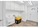 Functional laundry room offering plenty of storage space with white cabinets and laminate flooring at 9826 Meringue Pl # 15, Charlotte, NC 28270