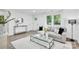 Comfortable living room featuring a large sofa, modern decor, and plenty of natural light at 9826 Meringue Pl # 15, Charlotte, NC 28270