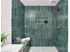 Beautiful shower with green tiling, rainfall shower head, and built-in niche with glass bottles at 9826 Meringue Pl # 15, Charlotte, NC 28270