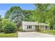 Charming single-story home with a well-manicured lawn, driveway, and light-colored siding at 9826 Meringue Pl, Charlotte, NC 28270