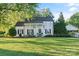 Charming white two-story home with rocking chair front porch and an American flag at 1020 12Th Nw Ave, Hickory, NC 28601