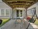 Charming back patio with pergola, swing, and glass table, perfect for outdoor entertaining at 10426 Kempsford Dr, Charlotte, NC 28262