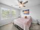 Bright bedroom featuring large windows, a ceiling fan, and a comfortable bed for restful nights at 10426 Kempsford Dr, Charlotte, NC 28262