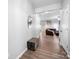 Inviting entryway showcases wood flooring, neutral walls, and a peek into the spacious and comfortable living room at 10426 Kempsford Dr, Charlotte, NC 28262
