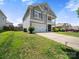 View of the side exterior featuring the well maintained lawn, driveway and two car garage of this home at 10426 Kempsford Dr, Charlotte, NC 28262