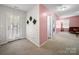 Hallway with neutral walls, carpeted floors, and doors leading to the home's interior spaces at 10426 Kempsford Dr, Charlotte, NC 28262