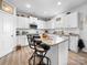 Bright kitchen with white cabinets, stainless steel appliances, granite countertops and a kitchen island at 10426 Kempsford Dr, Charlotte, NC 28262