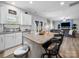 Kitchen with an island, white cabinets, stainless steel appliances, and an open view to the living room at 10426 Kempsford Dr, Charlotte, NC 28262