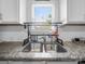 Kitchen features a stainless steel sink with granite countertops and a window at 10426 Kempsford Dr, Charlotte, NC 28262
