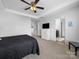 This main bedroom features a ceiling fan, carpeted floor, and ensuite bathroom for added convenience at 10426 Kempsford Dr, Charlotte, NC 28262