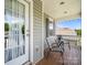 Relax on this charming porch, complete with seating, string lights, and a view of the serene neighborhood at 10426 Kempsford Dr, Charlotte, NC 28262