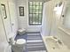 Compact bathroom with horizontal shiplap walls, a vintage sink, and walk-in shower at 1051 14Th Avenue Nw Dr, Hickory, NC 28601