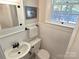 Traditional bathroom with a pedestal sink, wainscoting, and mosaic tile flooring at 1051 14Th Avenue Nw Dr, Hickory, NC 28601