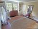 Bedroom with two windows, custom built-ins and an antique dresser at 1051 14Th Avenue Nw Dr, Hickory, NC 28601