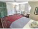 Bedroom includes antique dresser, windows, and a large rug, creating a cozy and unique space at 1051 14Th Avenue Nw Dr, Hickory, NC 28601