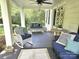 Relaxing covered front porch with wicker furniture, decorative pillows, and a ceiling fan for added comfort at 1051 14Th Avenue Nw Dr, Hickory, NC 28601