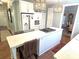 Kitchen featuring a large island with a cooktop, seating, stainless steel refrigerator, and ample storage at 1051 14Th Avenue Nw Dr, Hickory, NC 28601