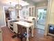 Charming kitchen features a large island with cooktop, farmhouse sink, and elegant pendant lighting at 1051 14Th Avenue Nw Dr, Hickory, NC 28601