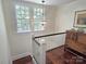 Upper landing with hardwood floors and an antique dresser in a naturally-lit space at 1051 14Th Avenue Nw Dr, Hickory, NC 28601