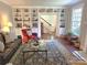 Bright living room features a built-in bookcase and plush seating around a glass coffee table with a decorative rug at 1051 14Th Avenue Nw Dr, Hickory, NC 28601