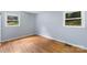 Sunlit bedroom featuring wood floors and dual windows at 1075 Parkview Dr, Gastonia, NC 28054