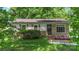 Charming home with brick accents, flowering garden beds, and a well-manicured front lawn at 1075 Parkview Dr, Gastonia, NC 28054