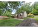 Charming home with well-maintained lawn and flowering garden beds leading to a covered carport at 1075 Parkview Dr, Gastonia, NC 28054