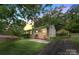 Charming home with well-maintained lawn and flowering garden beds leading to a covered carport at 1075 Parkview Dr, Gastonia, NC 28054