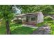 Charming home with well-maintained lawn and flowering garden beds leading to a covered carport at 1075 Parkview Dr, Gastonia, NC 28054
