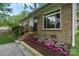 Charming home with brick accents, flowering garden beds, and a well-manicured front lawn at 1075 Parkview Dr, Gastonia, NC 28054